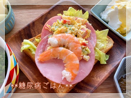 レタスの上に卵サラダとハム2枚、茹でエビを重ねたライ麦トーストのオープンサンドの糖尿病ごはん。